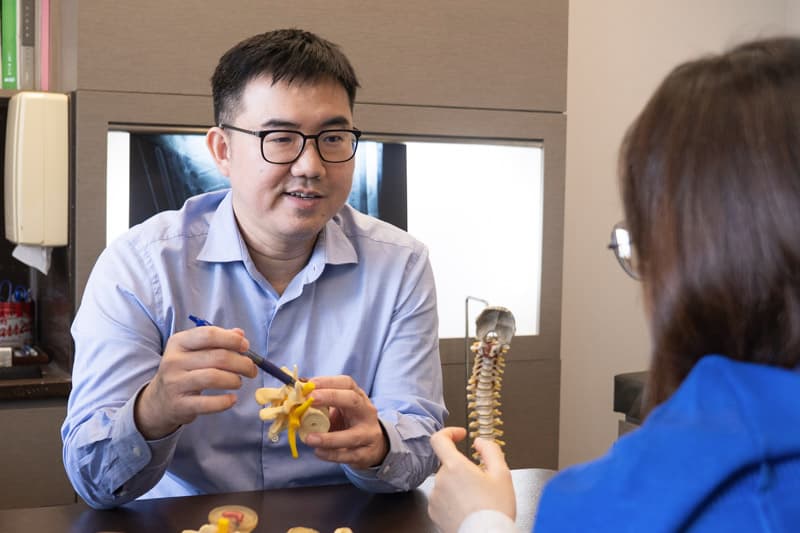 Dr Loo Wee Lim Explaining to Patient Treatment Options